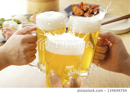 Toasting with beer mugs. Year-end party, New Year's party, farewell party 134699784