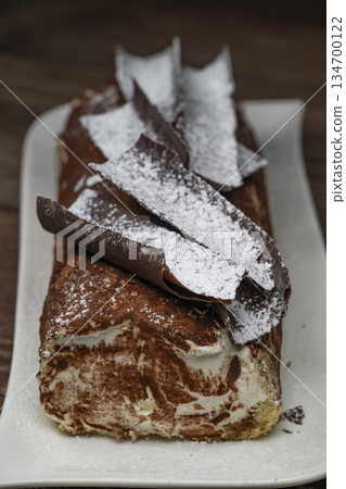 Tiramisu Tronchetto Dessert, Italian Yule Log Christmas dessert with chocolate bark Tiramisu Tronchetto Dessert, Italian Yule Log Christmas dessert with chocolate bark 134700122