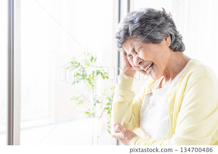 Senior woman with head ache 134700486