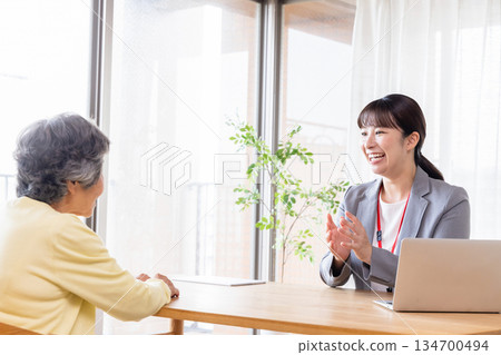 Businesswoman explaining to senior woman Businesswoman explaining to senior woman 134700494