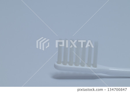 Close-up of a clean white toothbrush Close-up of a clean white toothbrush 134700847