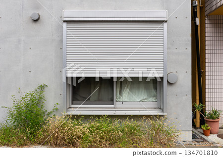 A closeup shot of automatic metal roller door used in factory, storage, garage, and industrial warehouse. The corrugated and foldable metal sheet offer space saving and provide urban and rustic feel 134701810