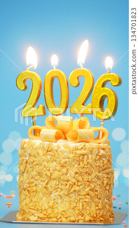 Happy New Year 2026, cute cake with golden ribbon with candle number 2026 for new year celebrate party was lit. blue background with light bokeh, vertical 134701823
