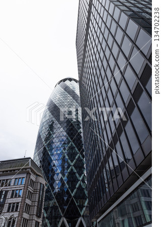Low angle view of The Gherkin skyscraper in London financial district Low angle view of The Gherkin skyscraper in London financial district 134702238
