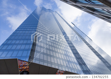 Modern Blue Glass Skyscraper Low Angle View Modern Blue Glass Skyscraper Low Angle View 134702255