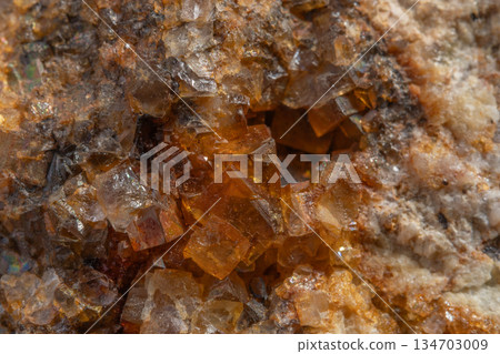 Stone with glowing orange crystals in rocky environment Stone with glowing orange crystals in rocky environment 134703009