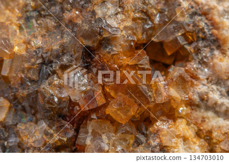 Stone with glowing orange crystals in rocky environment Stone with glowing orange crystals in rocky environment 134703010