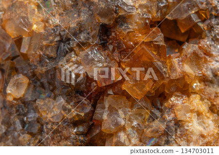 Stone with glowing orange crystals in rocky environment Stone with glowing orange crystals in rocky environment 134703011