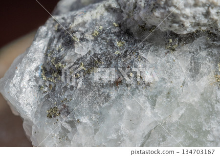 Close-up of stone with clear crystals and dark inclusions Close-up of stone with clear crystals and dark inclusions 134703167