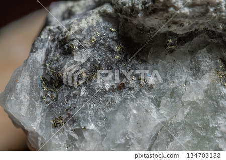 Close-up of stone with clear crystals and dark inclusions 134703188