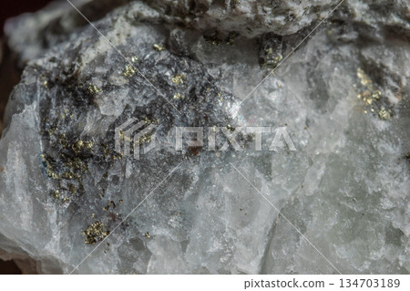 Close-up of stone with clear crystals and dark inclusions 134703189