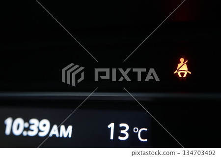 The seat belt warning light is on. A road safety alert. 134703402