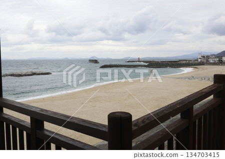 A view of the cloudy winter sky and stormy Seto Inland Sea seen through a wooden fence in Iyo City, Ehime Prefecture. A view of the cloudy winter sky and stormy Seto Inland Sea seen through a wooden fence in Iyo City, Ehime Prefecture. 134703415