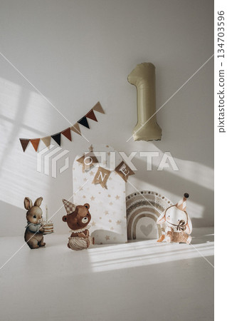 Animal themed party decorations, banner and large number one balloon set the stage for baby's first birthday celebration. Animal themed party decorations, banner and large number one balloon set the stage for baby's first birthday celebration. 134703596
