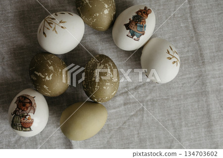 Easter holiday. Painted olive-colored eggs on a linen tablecloth. Easter decoration. 134703602
