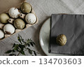 Easter holiday. Painted olive-colored eggs on a linen tablecloth. Easter decoration. 134703603