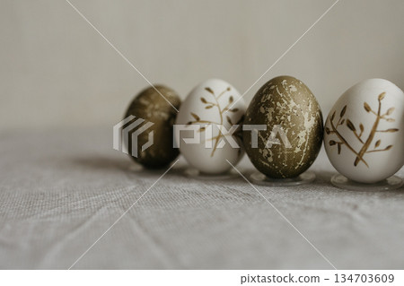 Easter holiday. Painted olive-colored eggs on a linen tablecloth. Easter decoration. Easter holiday. Painted olive-colored eggs on a linen tablecloth. Easter decoration. 134703609