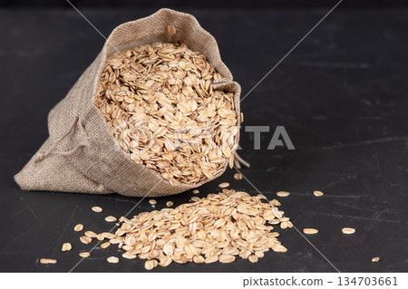 Oatmeal in a bag on a black background Oatmeal in a bag on a black background 134703661