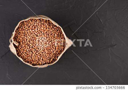 a bag of buckwheat on a black background a bag of buckwheat on a black background 134703666