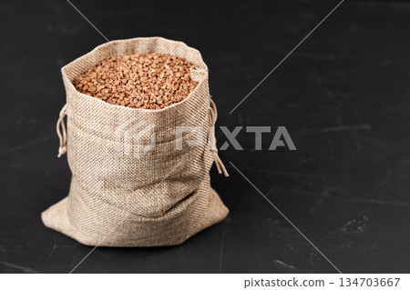 a bag of buckwheat on a black background 134703667