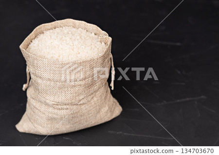 A bag of rice on a black background A bag of rice on a black background 134703670