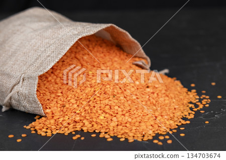 A bag of lentils on a black background A bag of lentils on a black background 134703674