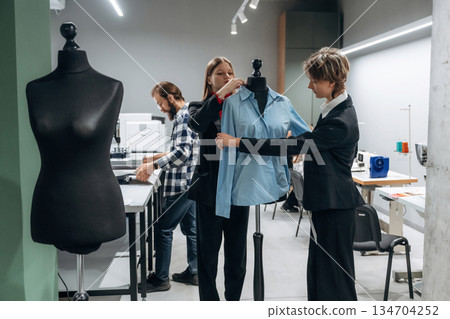 People are working by the sewing machines indoors People are working by the sewing machines indoors 134704252