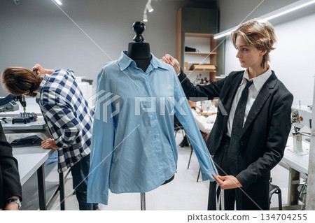 Fashion concept. People are working by the sewing machines indoors 134704255