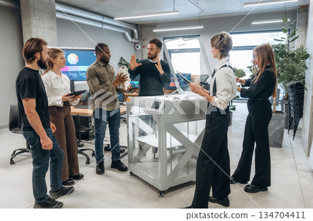 Employees are together. People are in the office by the 3d printer Employees are together. People are in the office by the 3d printer 134704411