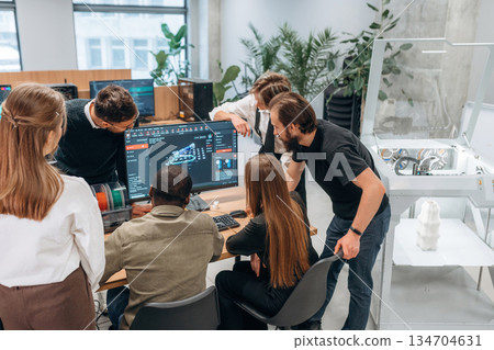 Exciting project, 3d printing. Designer team are together in the office 134704631