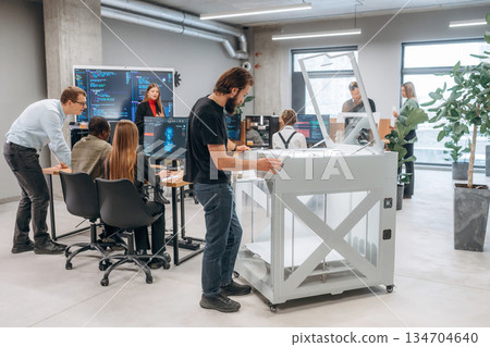 High quality 3d printer. People are in the office High quality 3d printer. People are in the office 134704640