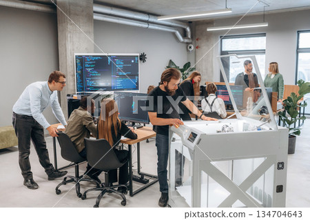People are in the office by the 3d printer 134704643