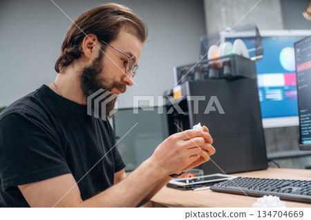 Computer with 3d printer. Man is in the modern office, one person Computer with 3d printer. Man is in the modern office, one person 134704669