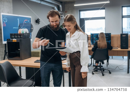 Man and woman are standing. Designer team are together in the office 134704738