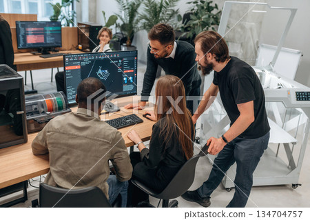 Working on a project together. Designer team are in the office 134704757