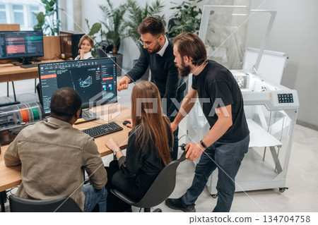 Working on a project together. Designer team are in the office Working on a project together. Designer team are in the office 134704758