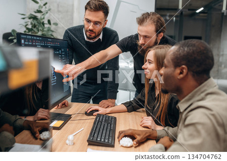 By computer. Designer team are together in the office 134704762