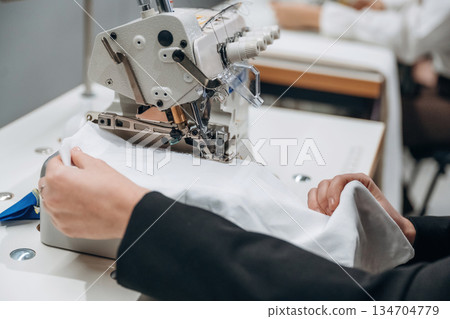 Close up view. Seamstress is working indoors Close up view. Seamstress is working indoors 134704779