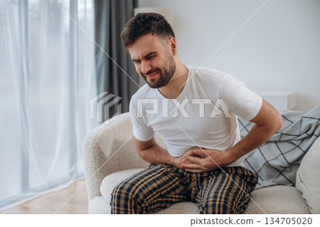 Abdominal pain. Sick man is feeling bad at home Abdominal pain. Sick man is feeling bad at home 134705020