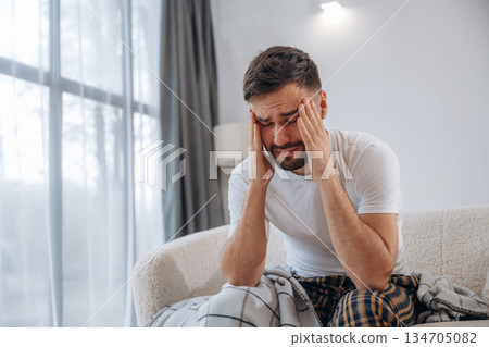 Terrible headache. Sick man is feeling bad at home 134705082