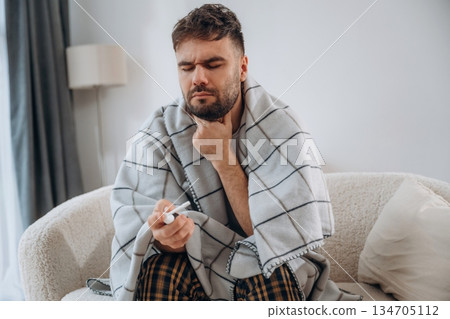Using throat spray. Sick man is feeling bad at home Using throat spray. Sick man is feeling bad at home 134705112