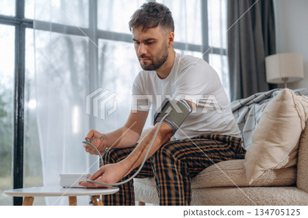 Blood pressure measuring. Sick man is feeling bad at home 134705125