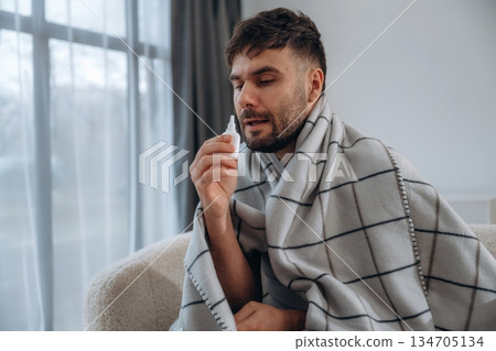 Nasal spray for nose. Sick man is feeling bad at home 134705134