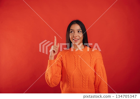 Showing up, copy space. Young beautiful woman is against background Showing up, copy space. Young beautiful woman is against background 134705347
