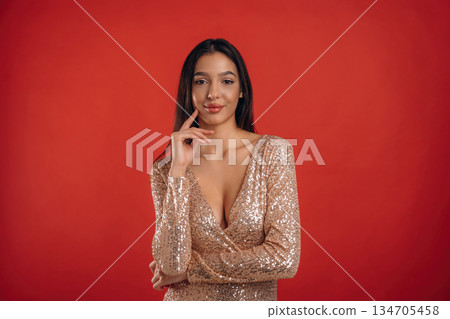 Looking forward, standing. Young elegant woman is against background 134705458