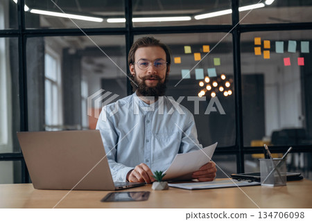 Friendly businessman is working in the office Friendly businessman is working in the office 134706098