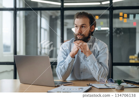 Front view, by laptop. Businessman is working in the office Front view, by laptop. Businessman is working in the office 134706138