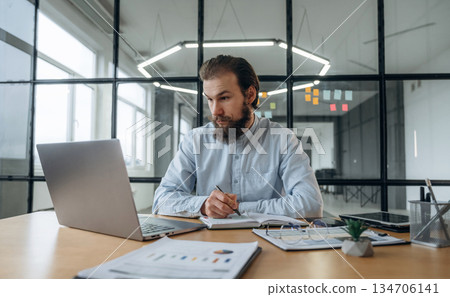 Focused at work. Businessman is in the office Focused at work. Businessman is in the office 134706141
