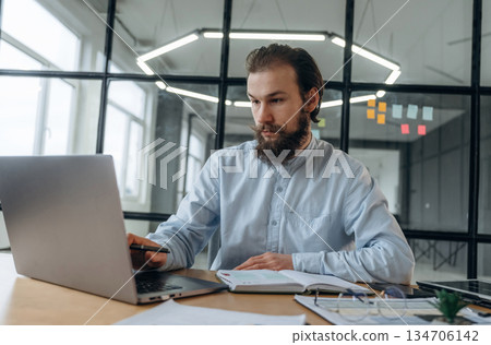 Focused at work. Businessman is in the office Focused at work. Businessman is in the office 134706142