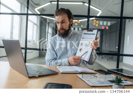 New plan, online conference. Businessman is working in the office New plan, online conference. Businessman is working in the office 134706144